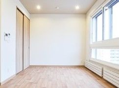 全体的に白っぽい居室。窓が大きく外の風景もよく見える。
