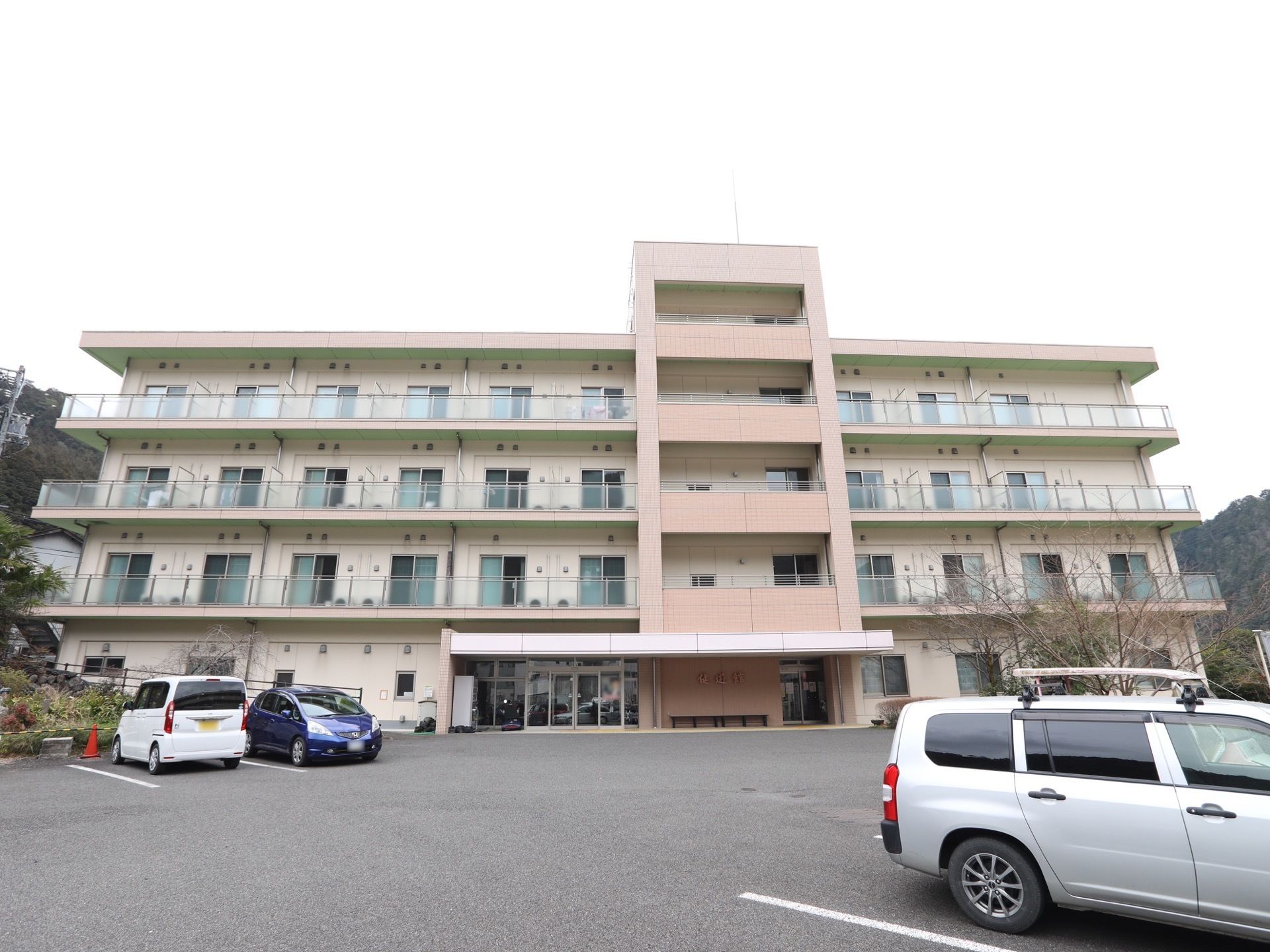 ４階建ての住宅があり、敷地はアスファルト舗装された駐車スペースになっている。各居室にはベランダが付いている。