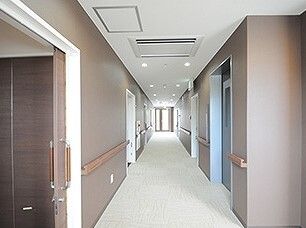 高齢者と一緒にカルテのようなものを眺めている施設内スタッフとの2ショット