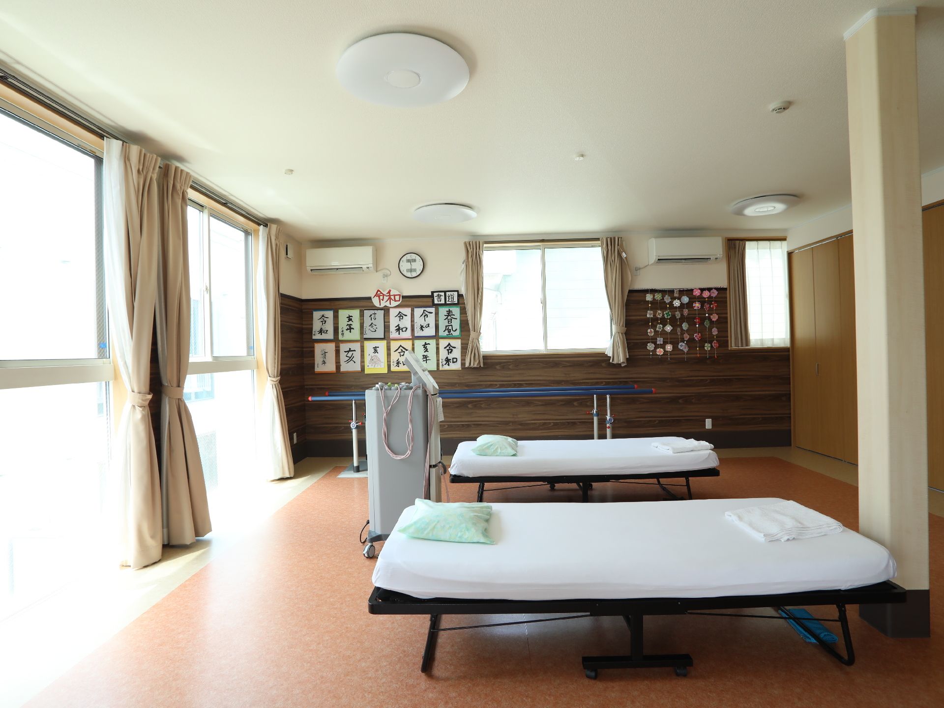 整体用の施術台や歩行練習用の手すりが置かれた広い部屋