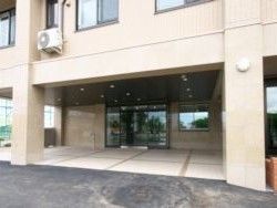 鉄骨造の建物のエントランス部分。高齢者向け施設なのでエントランスもオールバリアフリーにしてあるようす
