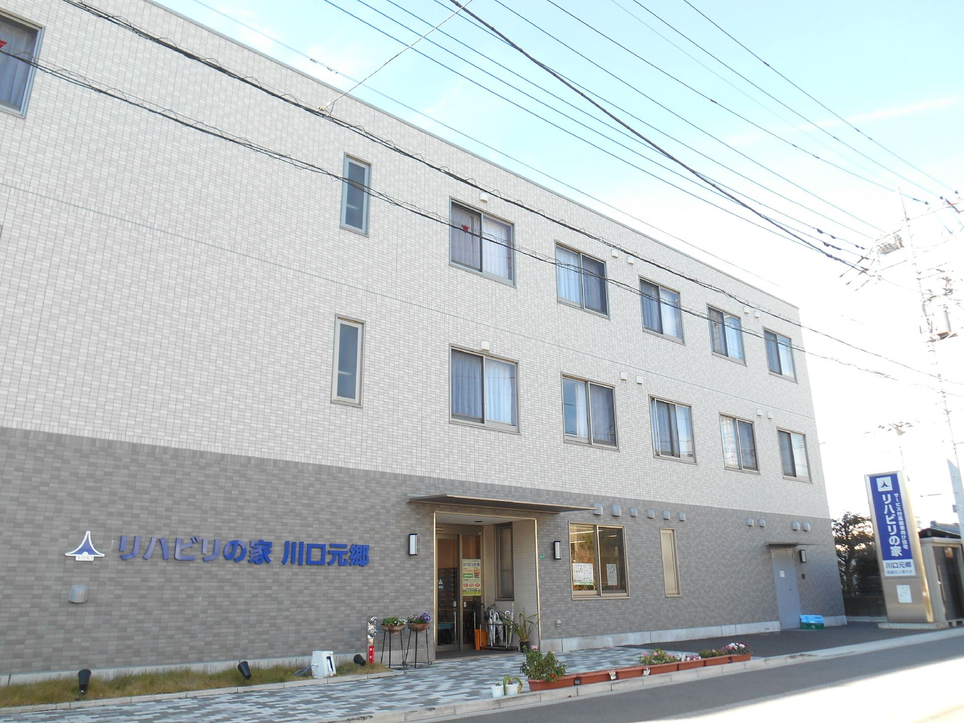 ツートンカラーの施設の外観写真。施設名が壁に書いてある様子