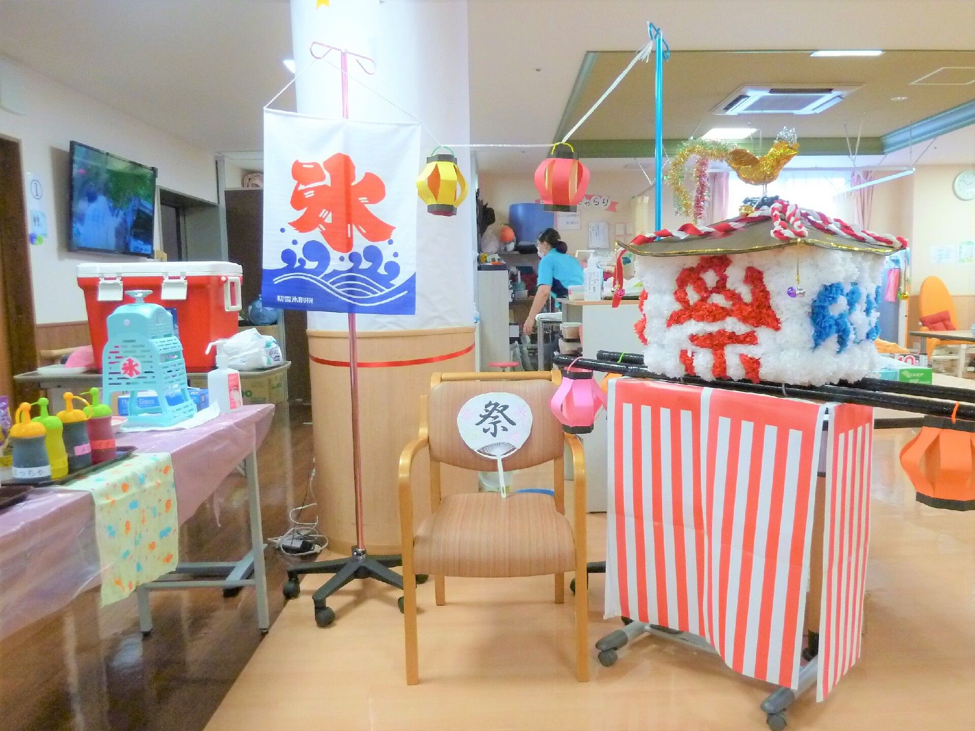 氷の屋台やゲームが並べられている施設内の夏祭り会場の様子