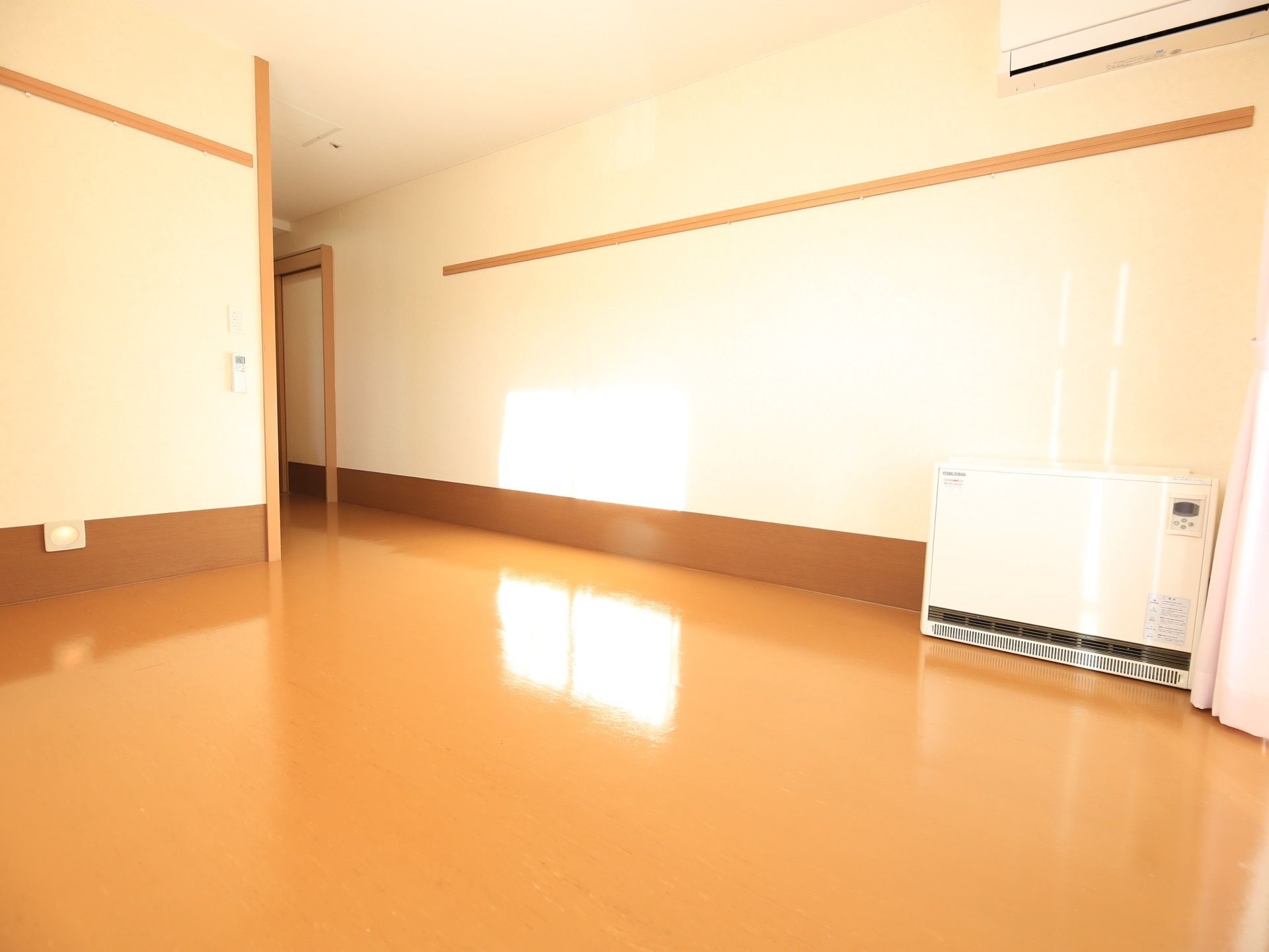 居室の床は木目調のフローリングになっていて温かみがある。エアコンを設置しているので、気持ちよく過ごすことができる。