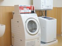 ドラム式の洗濯機と縦型の洗濯機があり、縦型の洗濯機の上には乾燥機も設置されている。