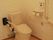 手すりが複数ついている施設内のトイレの様子。車いすのまま入れるトイレ