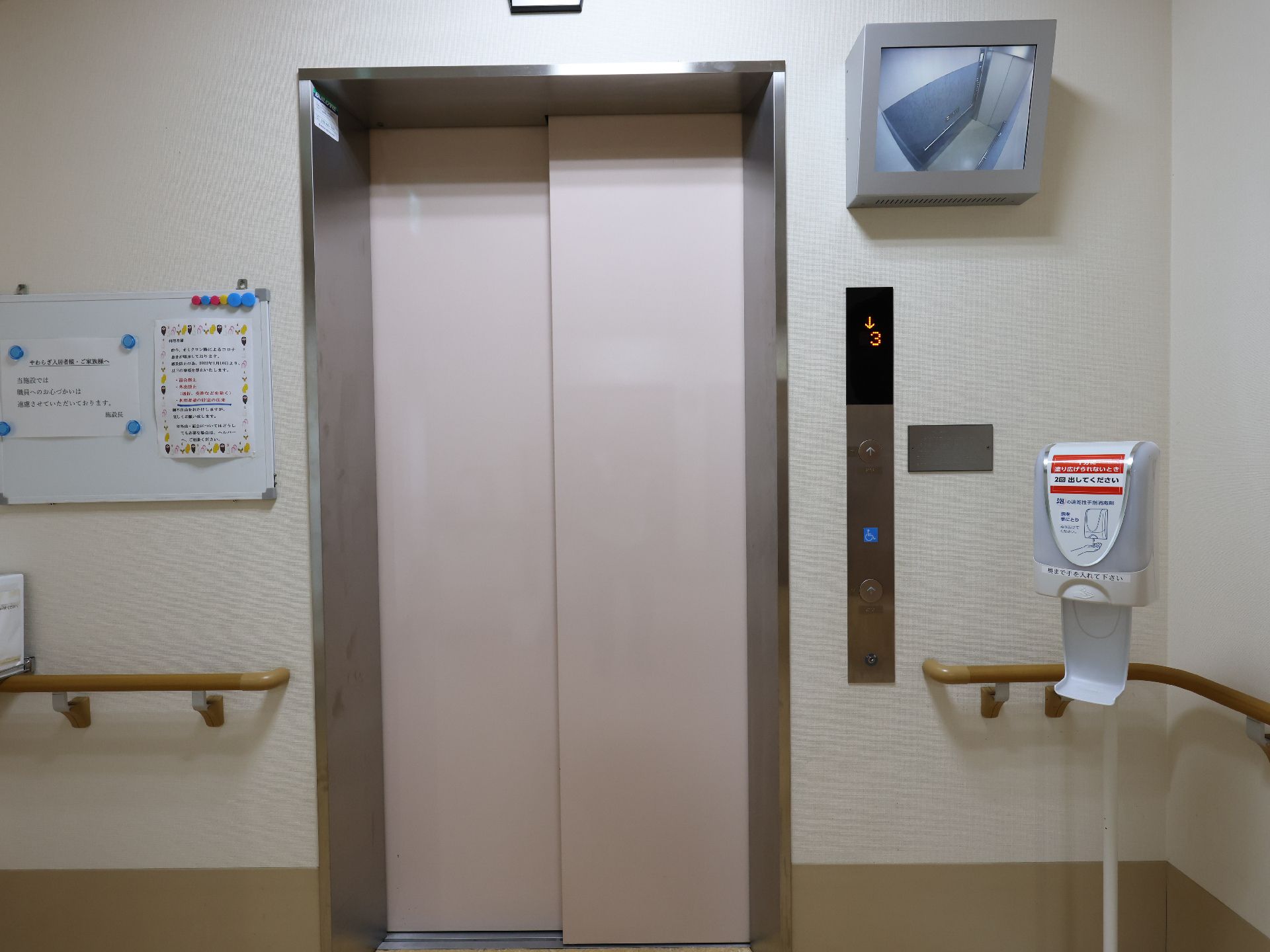 車いすから立ち上がろうとしている男性とそれを補助しようとしている女性スタッフの様子