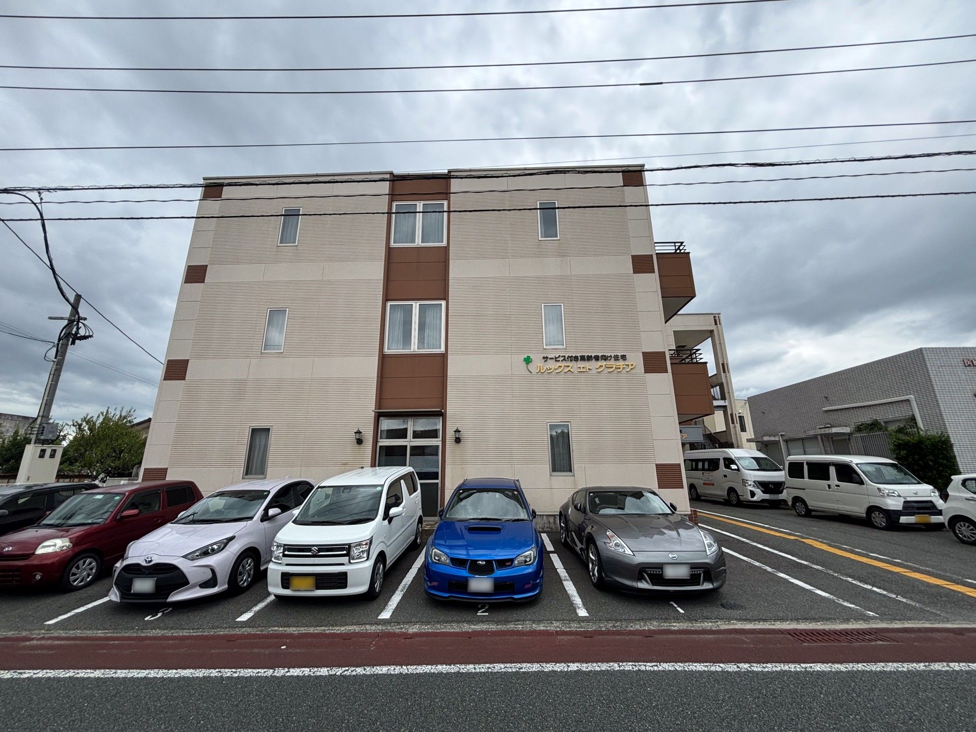 多様な車が停まる建物正面