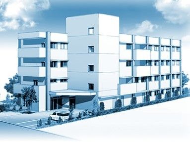 2棟続きの4階建ての建物にはベランダと駐車場もあり、周辺には緑が植えられている。