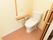扉は大きく開閉する引き戸である。温水便座トイレの横には、立ち座りを安全にできるよう手すりを設置している。