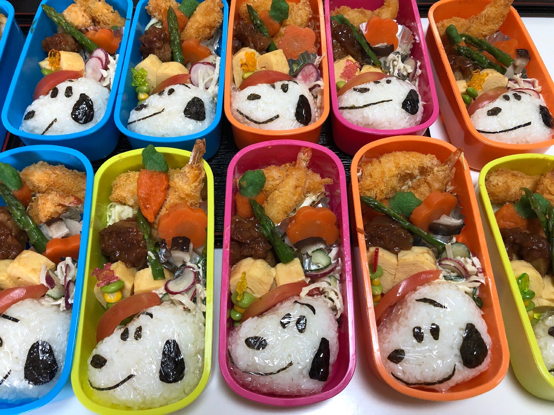 スヌーピーの顔が書いてあるご飯とおかず類が入ったお弁当箱の様子