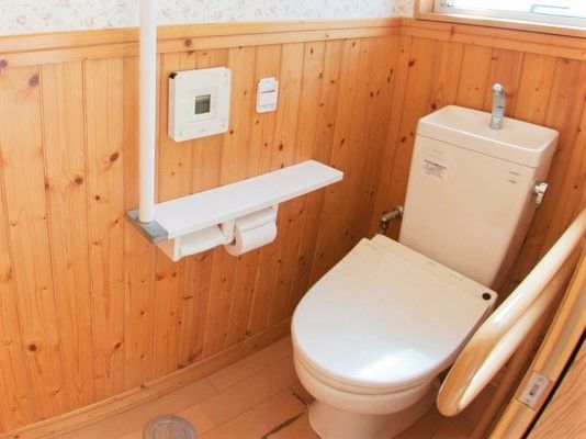 操作パネルや手すしや洗面所が付いたトイレは広く、フローリング。