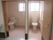 手すりが付いたトイレが二つ並んでいる。右手のドアは引き戸で、左手のドアは引き戸。