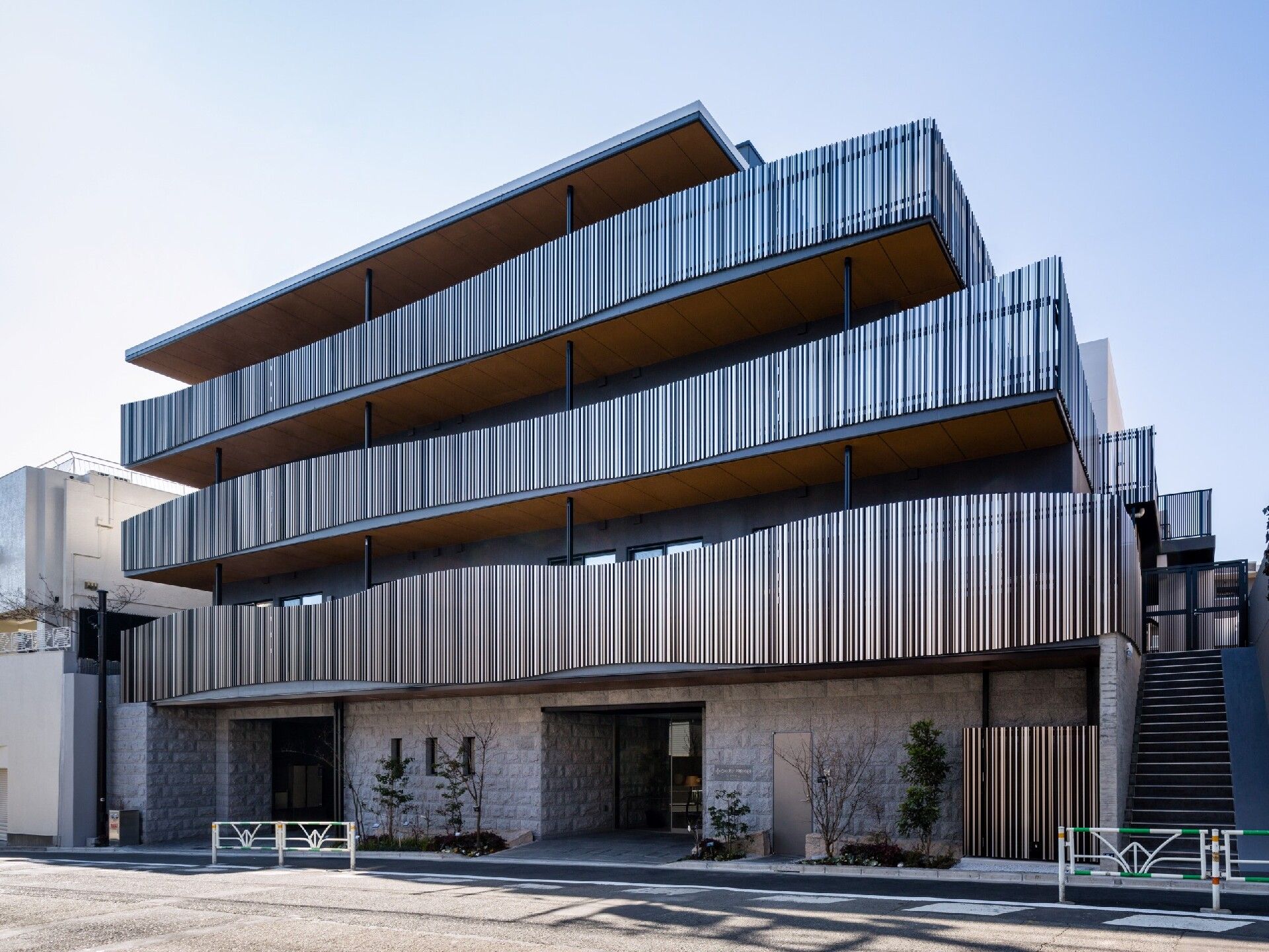 ４階建ての建物は各フロアにベランダが付き、凝ったデザイン。１階部分には駐車スペースもある。