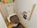 ブラウン系のマットが敷かれたトイレには手すりや呼び出しボタンもついている。