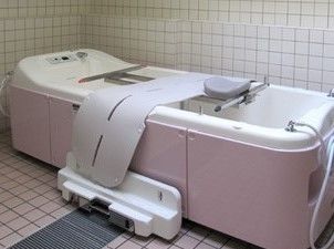 寝たまま入ることができる寝台浴が設置された浴室。