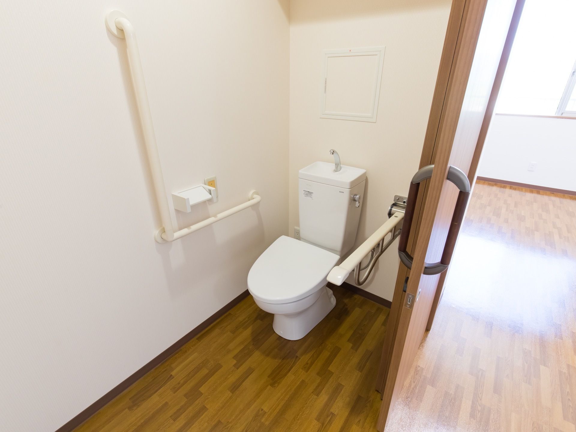トイレにはナースコールをはじめ、L字型や可動タイプの手すりを設置している。引き戸のため、車椅子での利用もストレスなく行える。