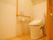 居室にある個室トイレは、引き戸の扉を採用している。温水洗浄機能がついた便座が完備されている。壁には手すりがある。