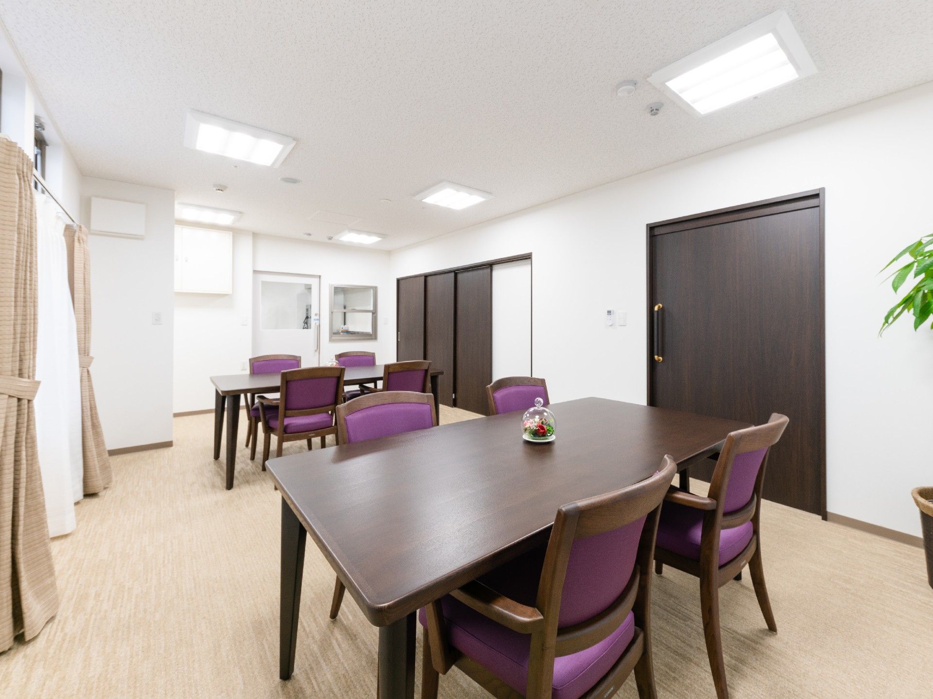 茶色い床に茶色いテーブルと茶色い椅子が置かれたシックな部屋