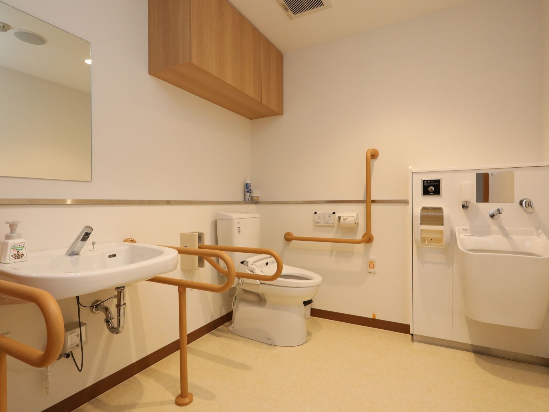 共用トイレの室内。車椅子のまま使えるタイプのため、部屋のスペースは広く、便座本体はコーナーに配置されている。