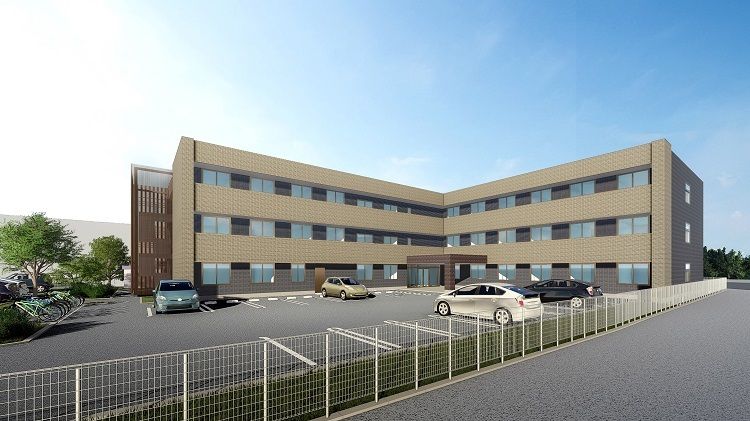 3階建ての建物はすっきりとしたスタイリッシュな外観で、玄関には屋根もあり、広い駐車場も付いている。