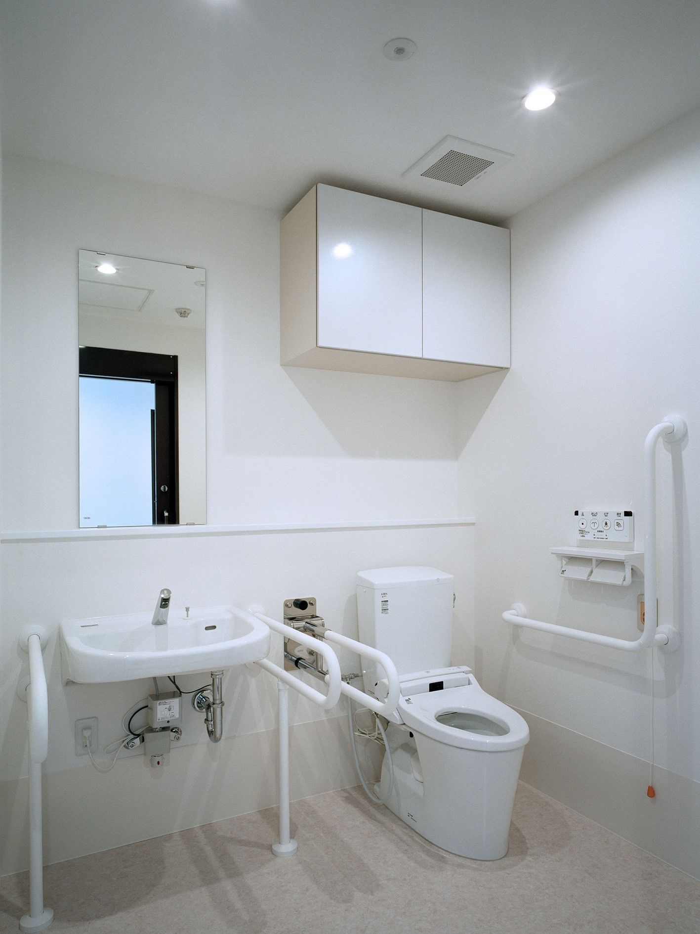 手すり付きの高齢者用トイレと洗面台。車いすのまま入れるスペース