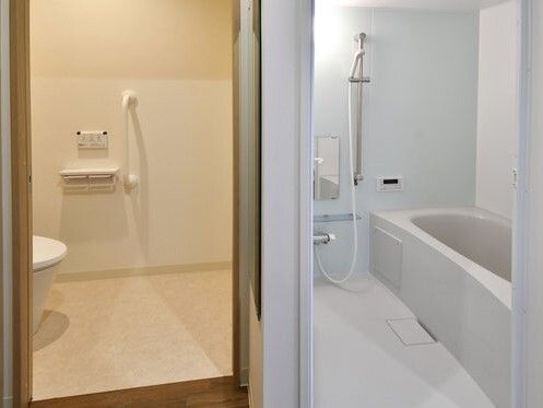手すり付きのトイレは広く、すぐそばに洗い場の広い浴室も設置されている。浴室にはシャワーもある。