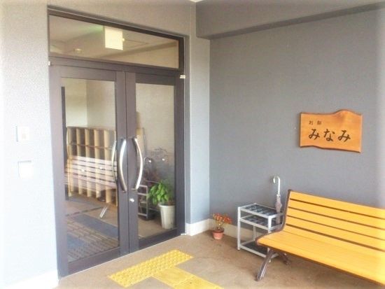 別邸みなみの看板が掲げられているエントランス。休憩用のベンチが置いてある様子