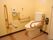 トイレの壁には横や縦方向の手すりが取り付けられており、トイレットペーパーホルダーが２個設置されている。