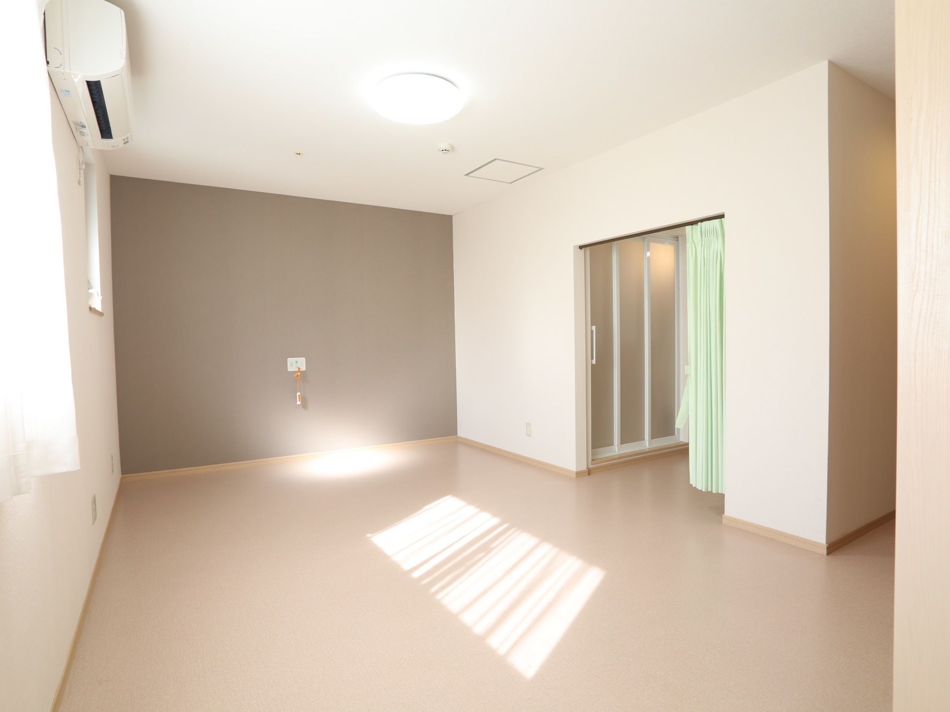 広い居室である。ナースコールやエアコンが備えている。脱衣所と居室の間はライムグリーン色のカーテンで仕切られている。