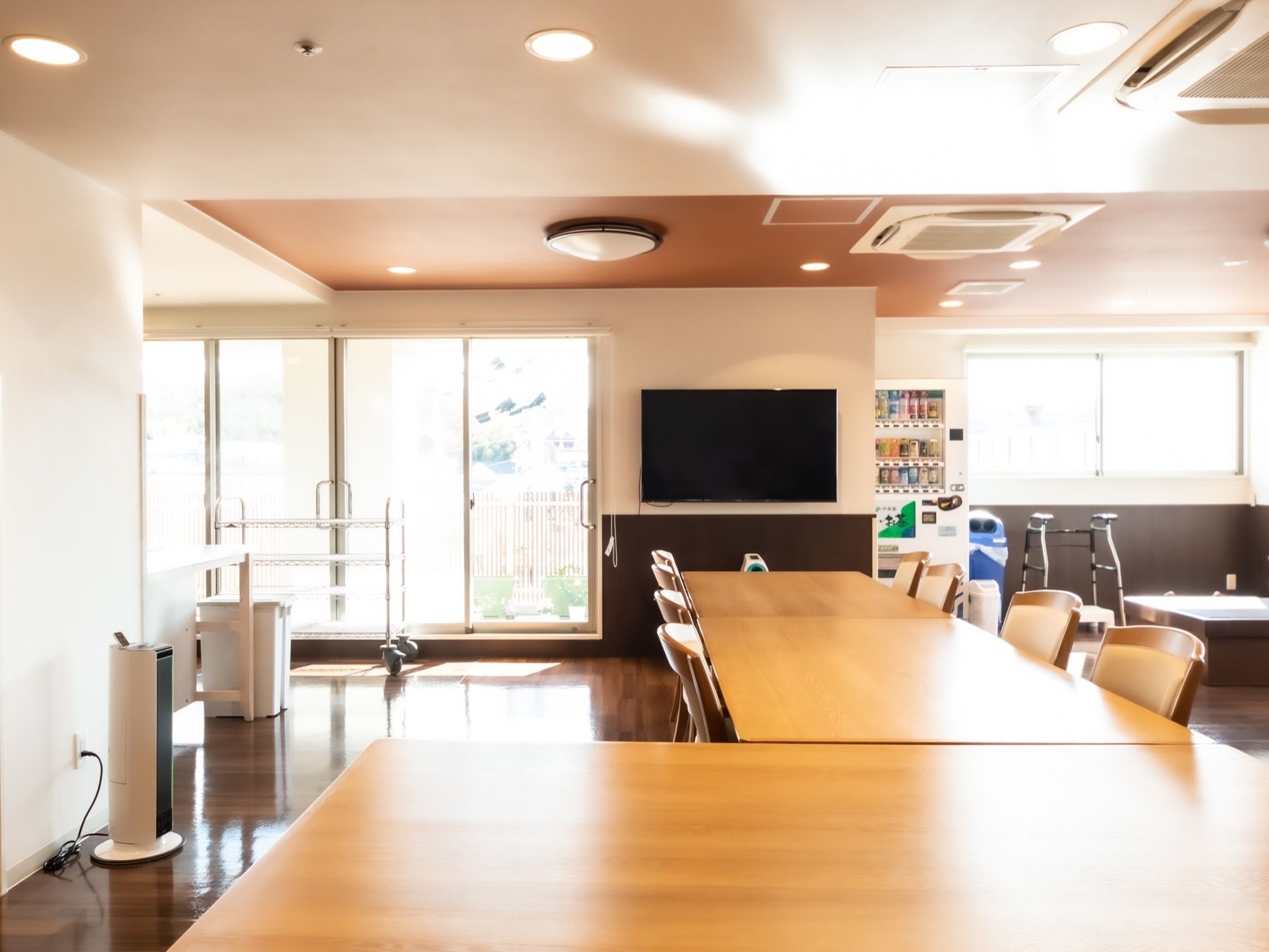 食堂には庭に面した大きな窓があり、日当たりは良好。自動販売機も設置され、手軽に好きな飲料を購入できる。