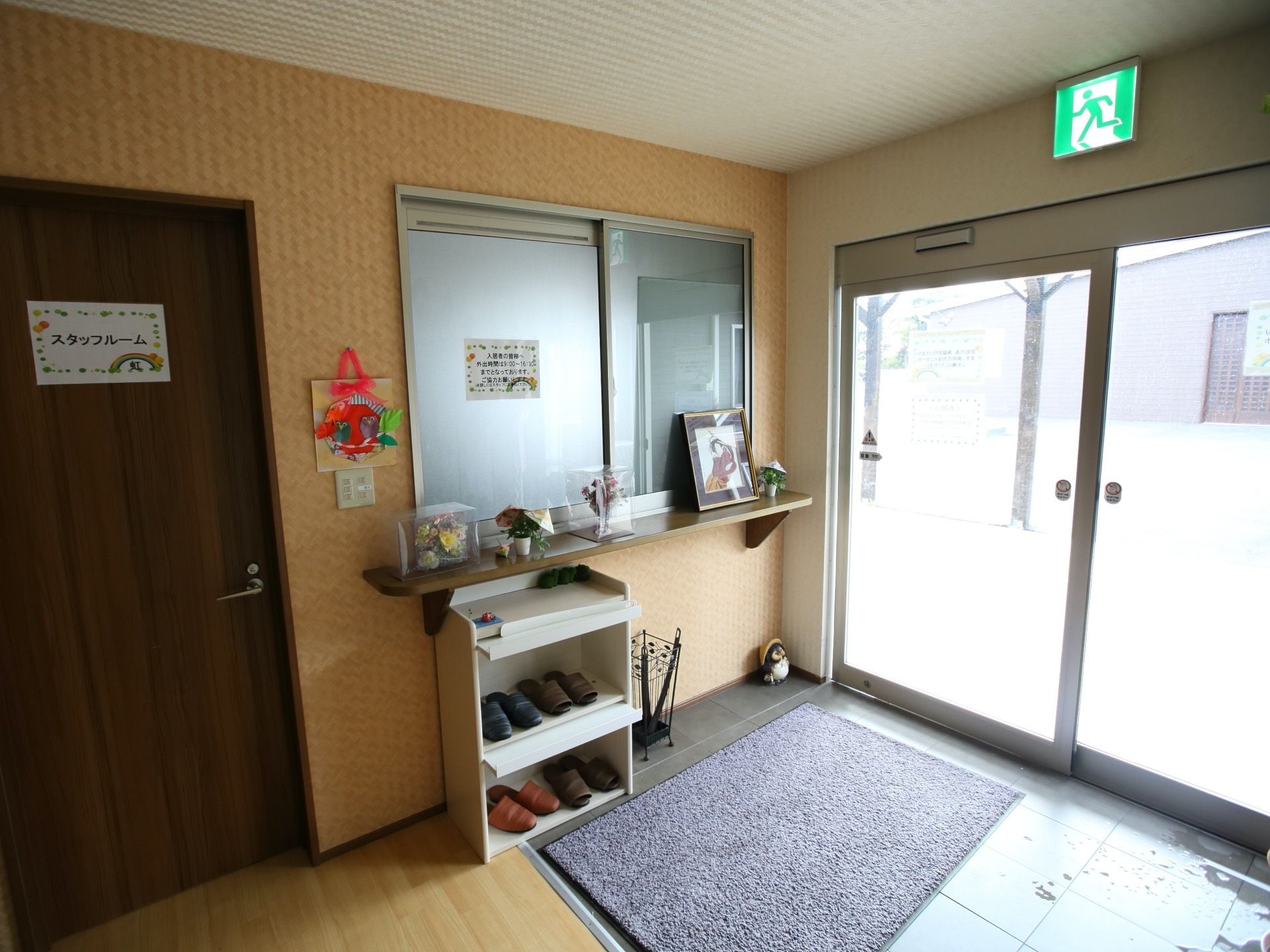 内部と外部の段差が少ない設計。玄関部分は自動ドアとなっている。入ってすぐ右手側に事務スペースがある。