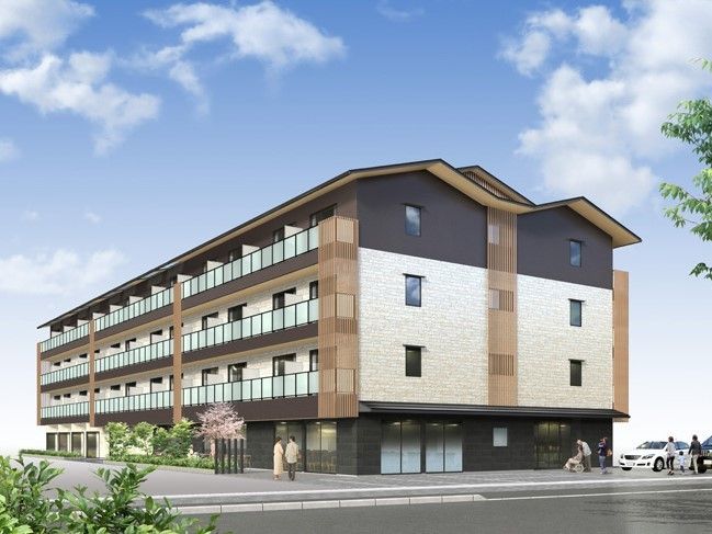 鉄骨造４階建ての施設の外観。モダンな色合いのデザインが印象的な建物