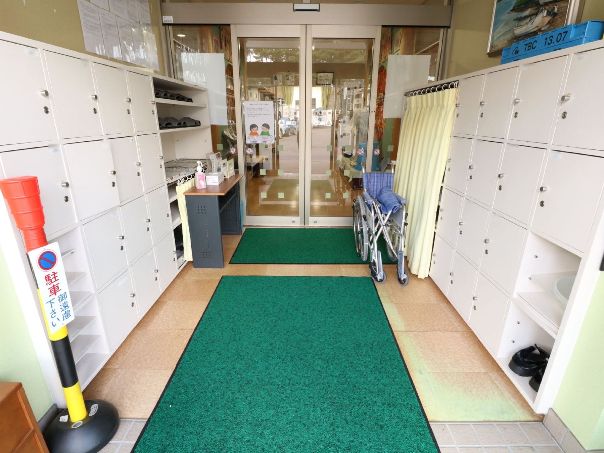 施設のエントランスは衛生のため、ドアを２重構造にしている。間の風除室に靴箱が設置され、外の汚れを中に持ち込まない工夫がされている。
