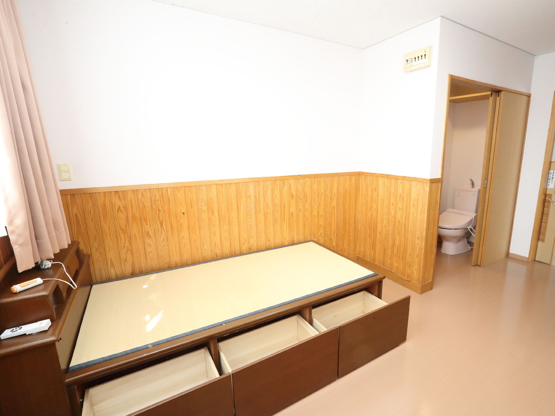 窓から日差しが注ぎ、介護ベッドが置かれている居室