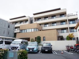 広い駐車場が隣接している、おしゃれな屋根のある介護施設