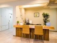 廊下には手すりが付き、生活相談コーナーは暖色系の照明の下にある木製のテーブル。