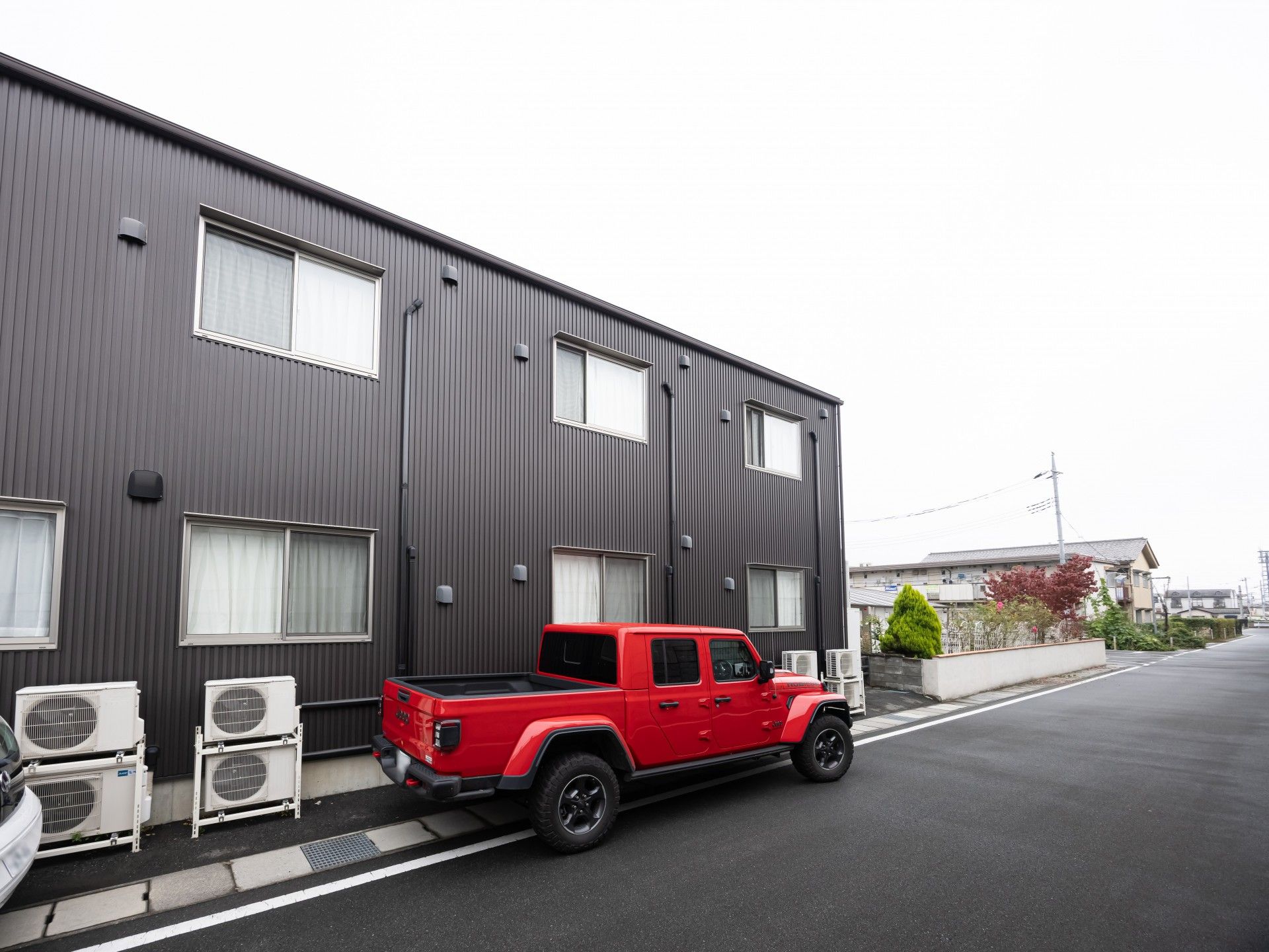 赤い車が停まる建物前