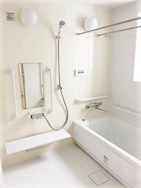 家庭によくあるサイズの浴室の写真。施設用の手すりがついている様子