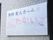 施設の外壁に、施設名が書かれた四角い光沢のある表札が取り付けられている。横には、窓が設置されている。