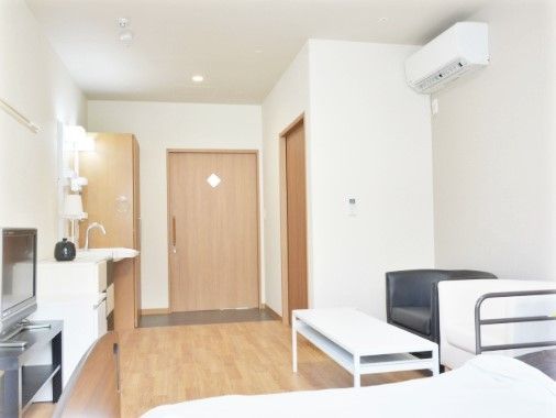 白い壁の部屋。ドアは木製である