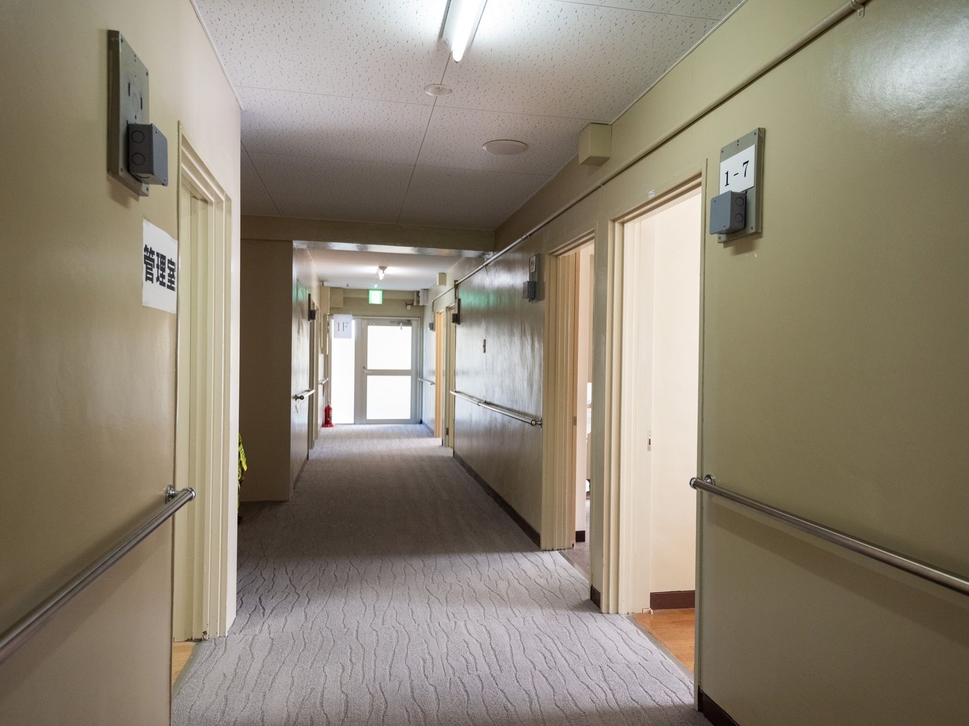 廊下の突き当たりは、非常口となっている。天井に避難誘導灯が取り付けてある。廊下の両壁には、ステンレス製の手すりが付いている。