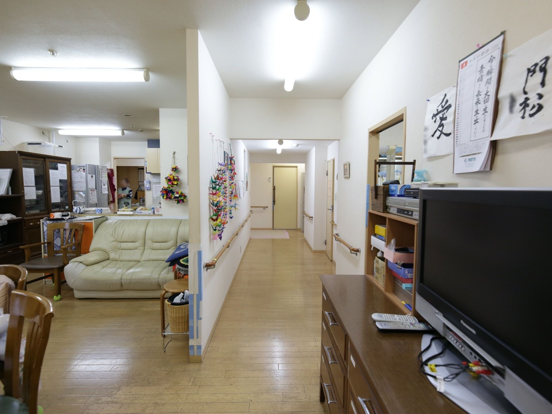 廊下から食堂につながっている。食堂の入口に近い所に、横長の収納棚が置かれ、その上にテレビが載せられている。