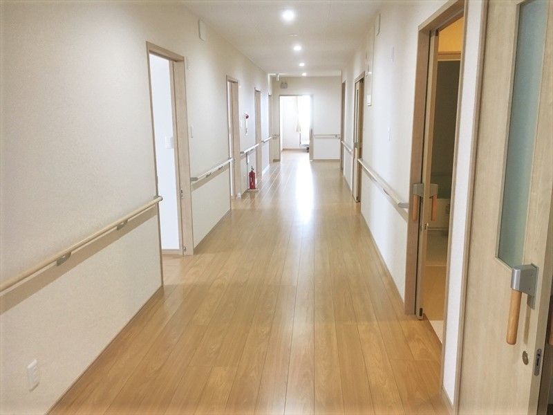 手すりと居室の入り口が見えている居室内の廊下の様子