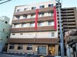 5階建ての建物の各フロアにはベランダが付き、建物の前には駐車場がある。