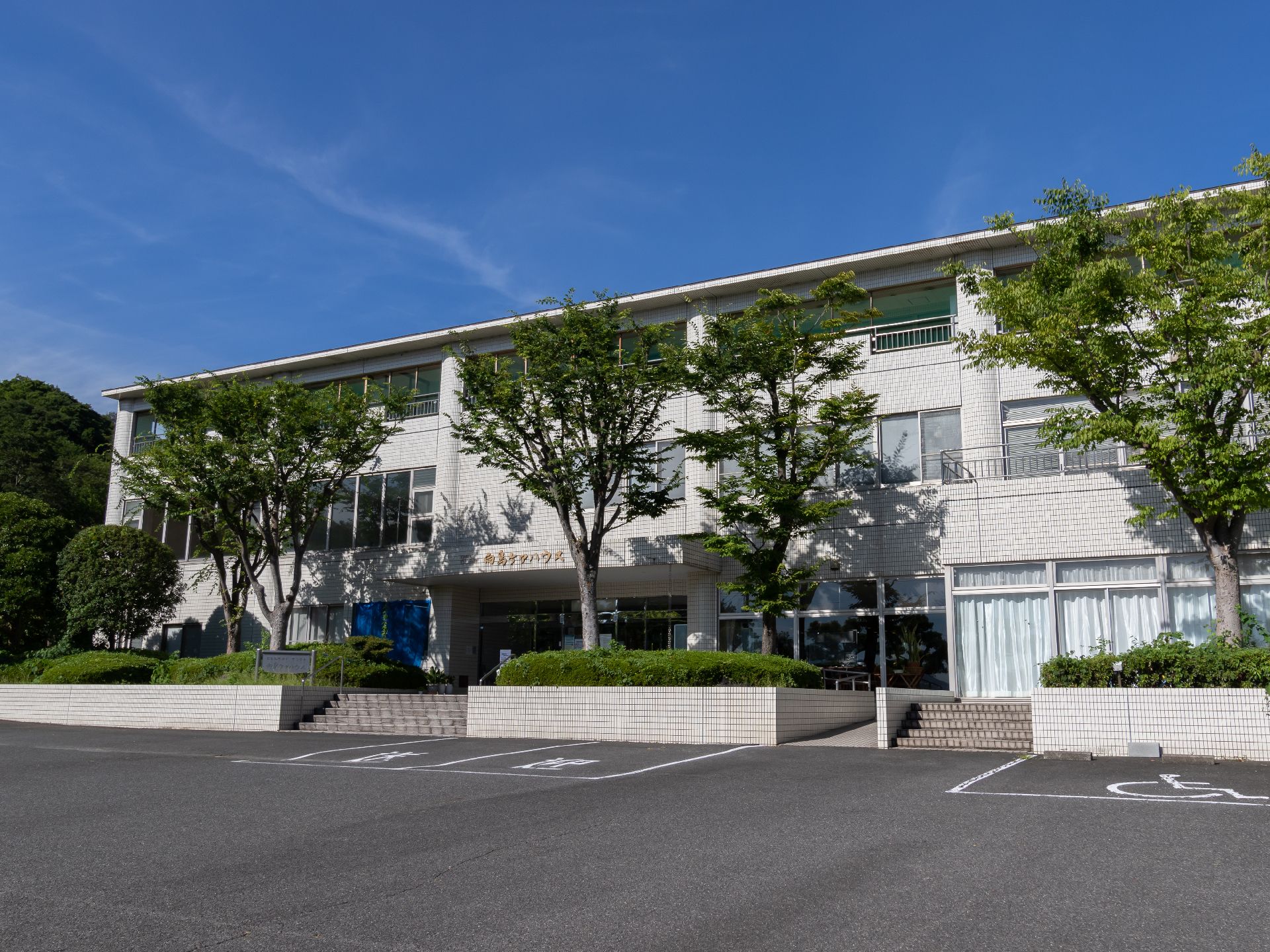 アスファルト沿いに立地している白い外観の建物