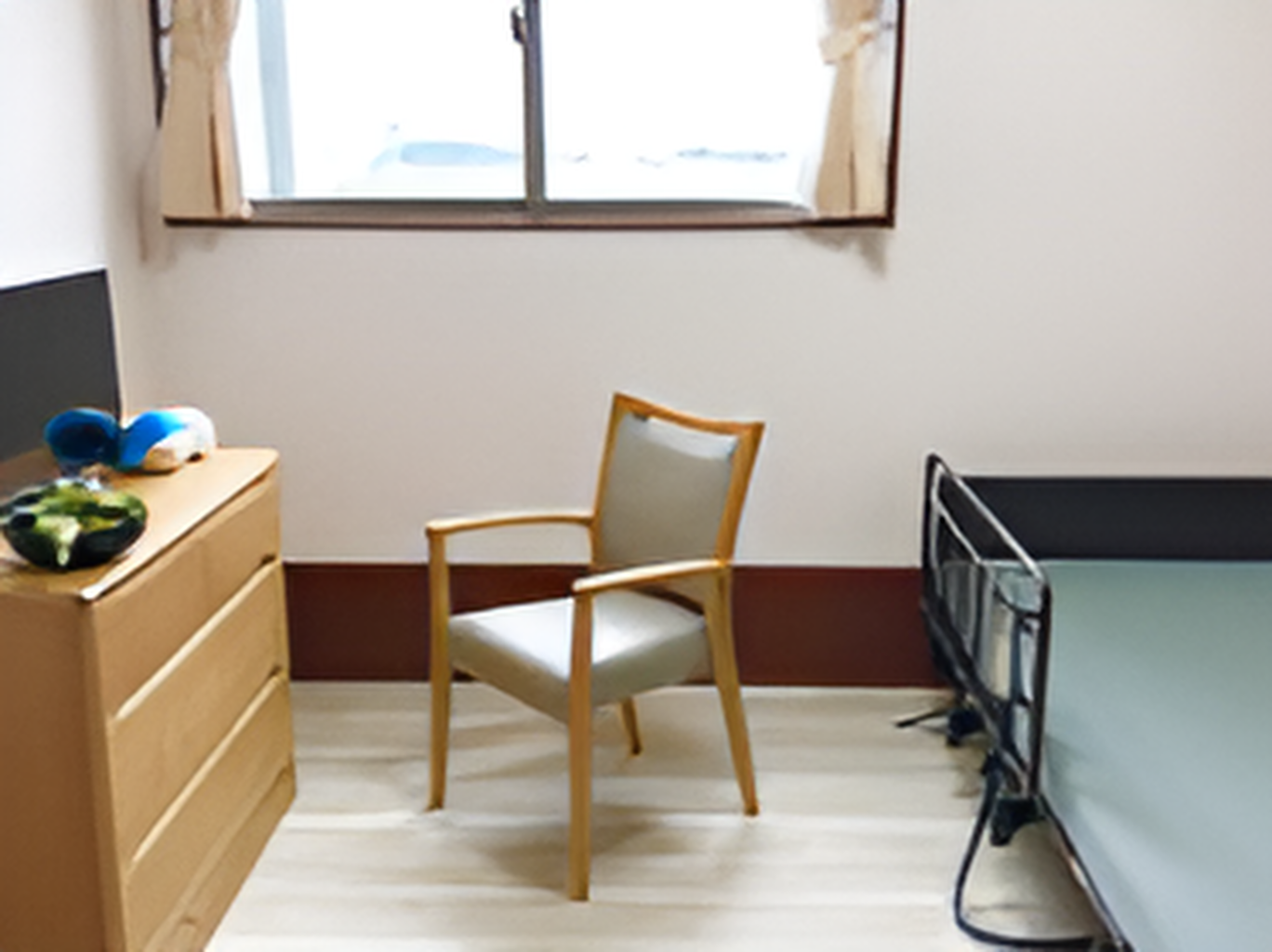 大きな窓が付いたフローリングの部屋には介護ベッドやタンス、テレビ、いすなどが置かれている。