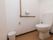 トイレには手すりを完備。縦と横の手すりで、体の不自由な方もより安心である。便座前には広いスペースがあり、車いすの方も安全に利用できる。