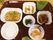 卵料理や青菜の和え物、おかゆなどが並んだブラウンのトレー。