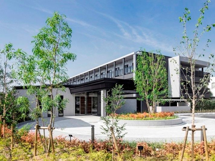 ３階建ての建物には大きな車寄せが付き、周辺には色とりどりの草木が植えられている。